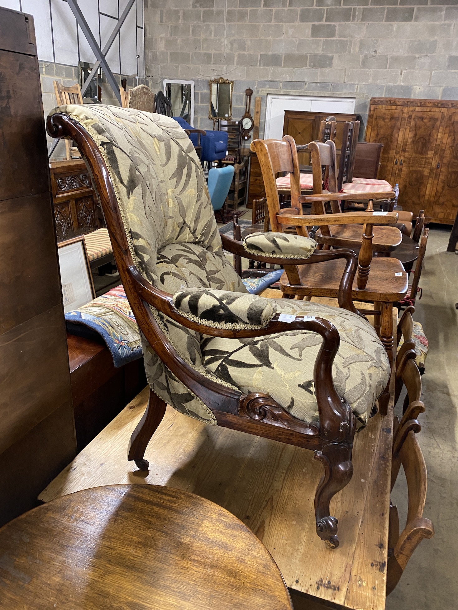 A Victorian rosewood upholstered open armchair, width 65cm, depth 72cm, height 95cm